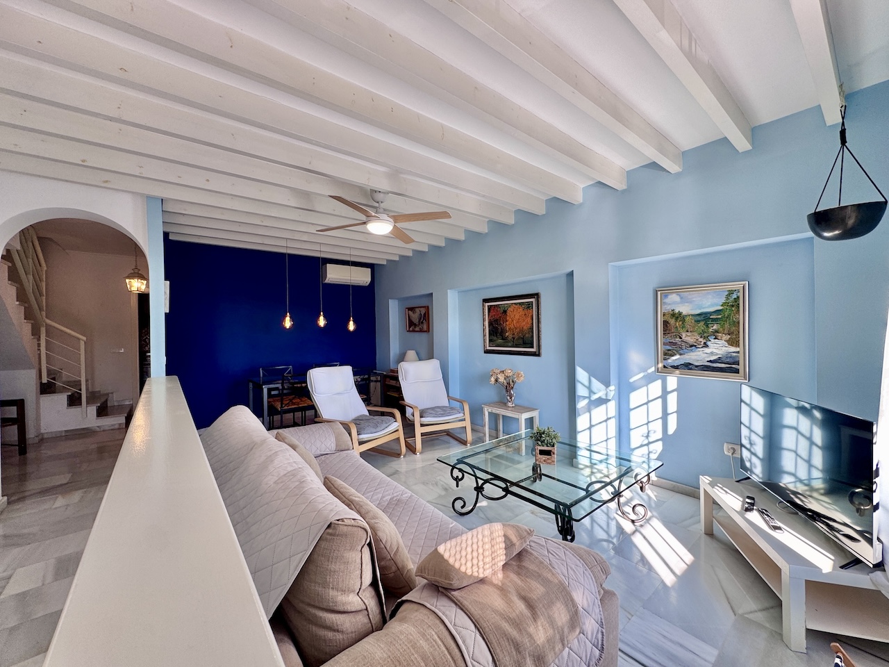 Spacious living room with white beamed ceilings