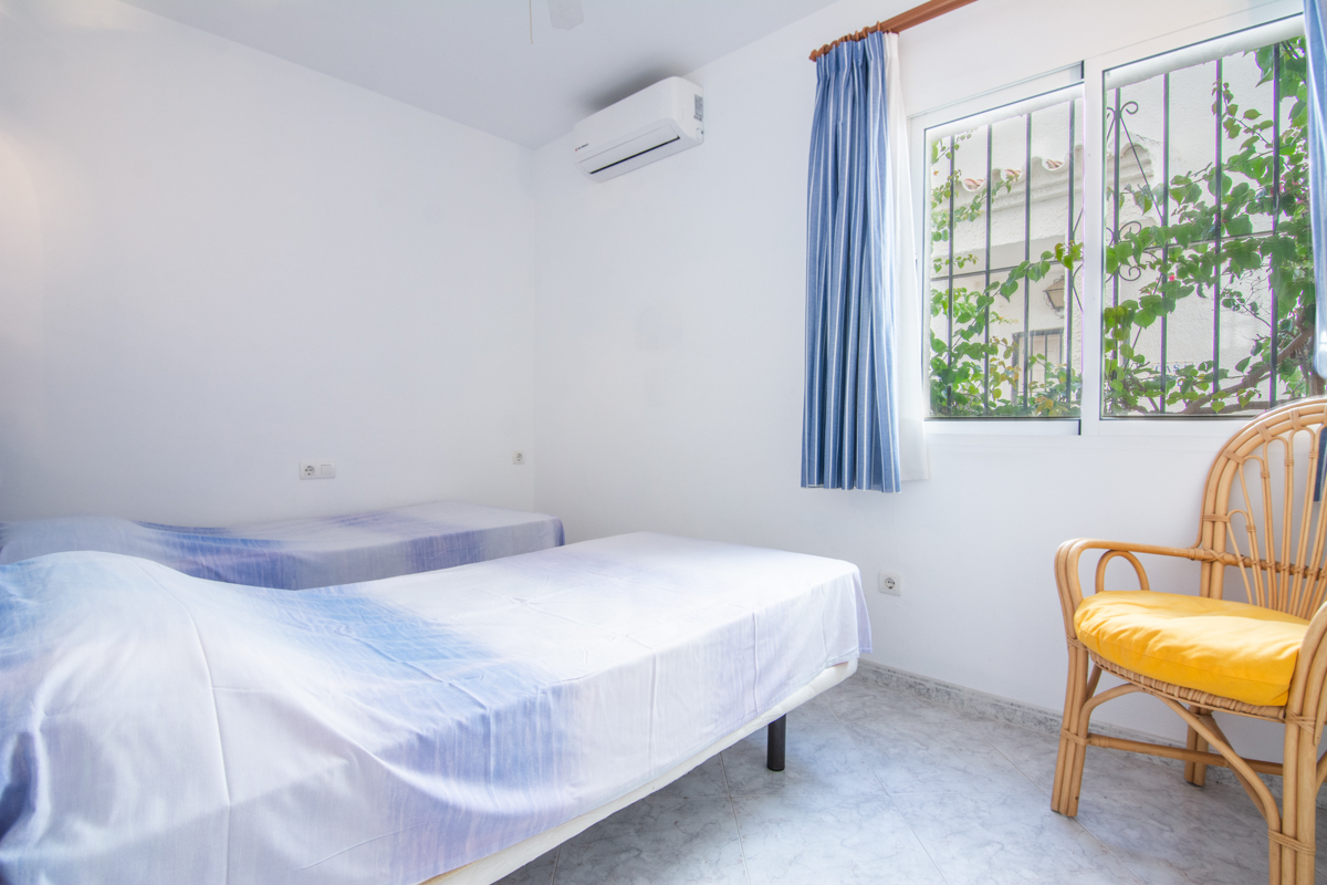 Bedroom with twin beds and side window