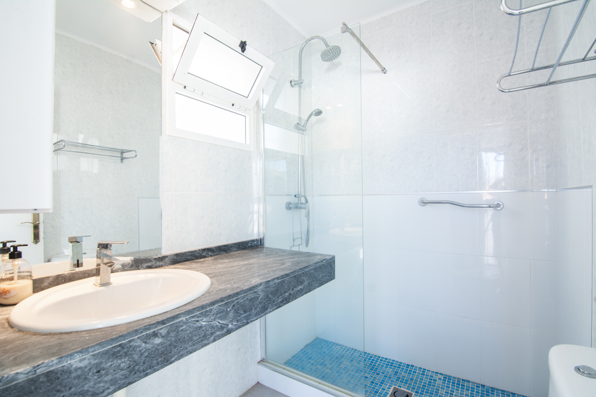 Bathroom with walk-in shower and modern sink