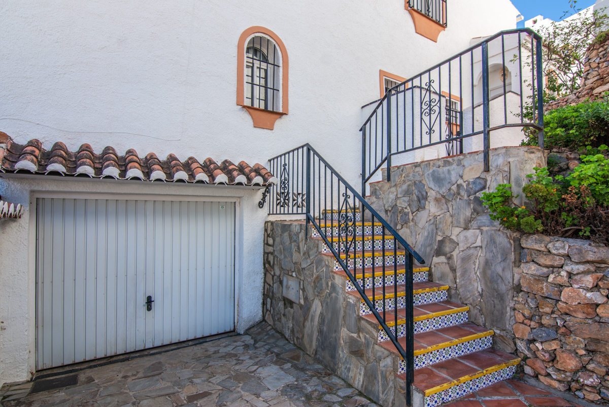 Exterior entrance with garage and access stairs
