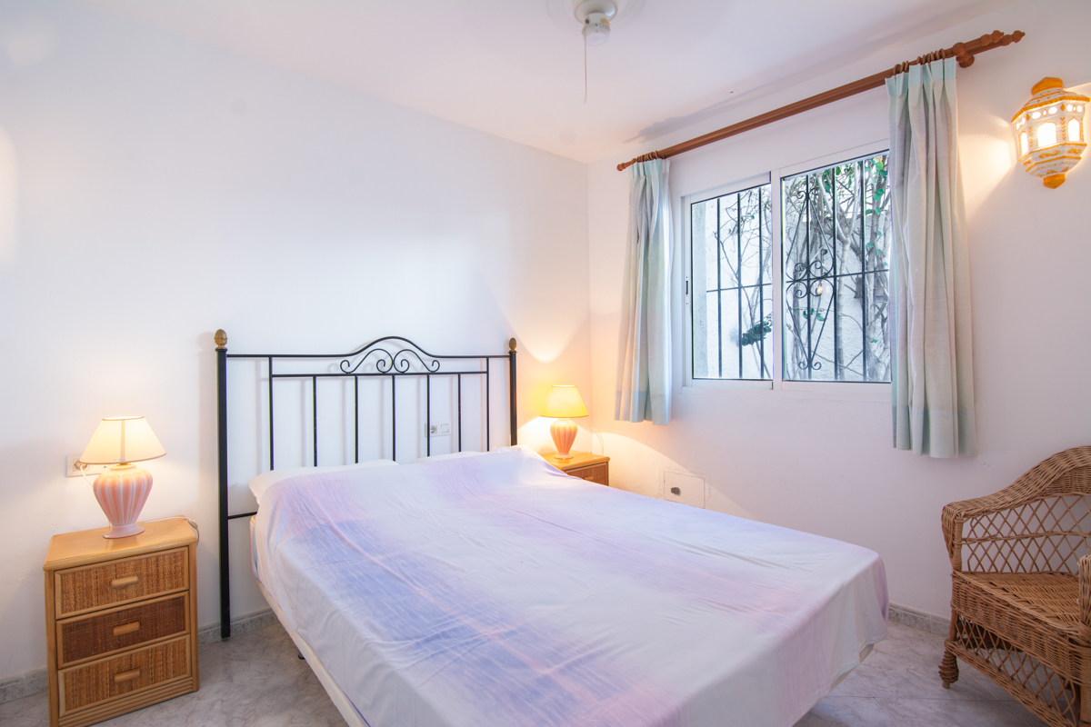 Bedroom with double bed and interior window