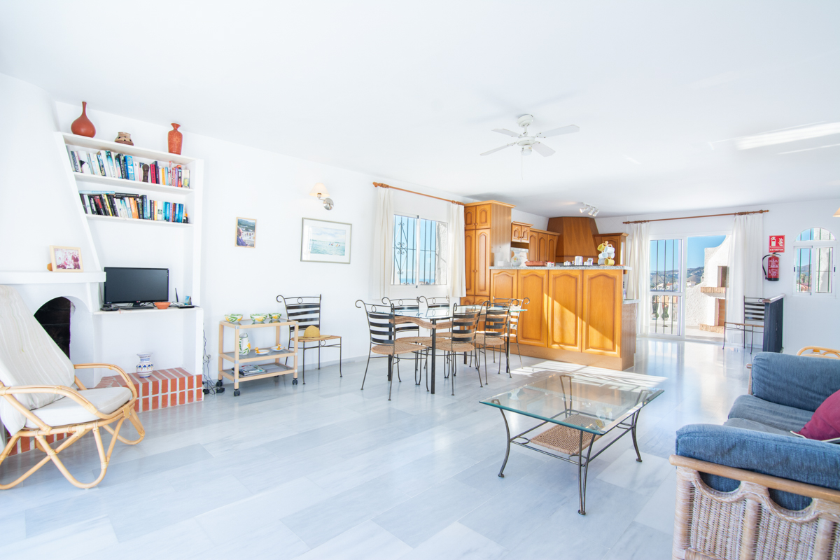 Open living-dining room with kitchen and fireplace