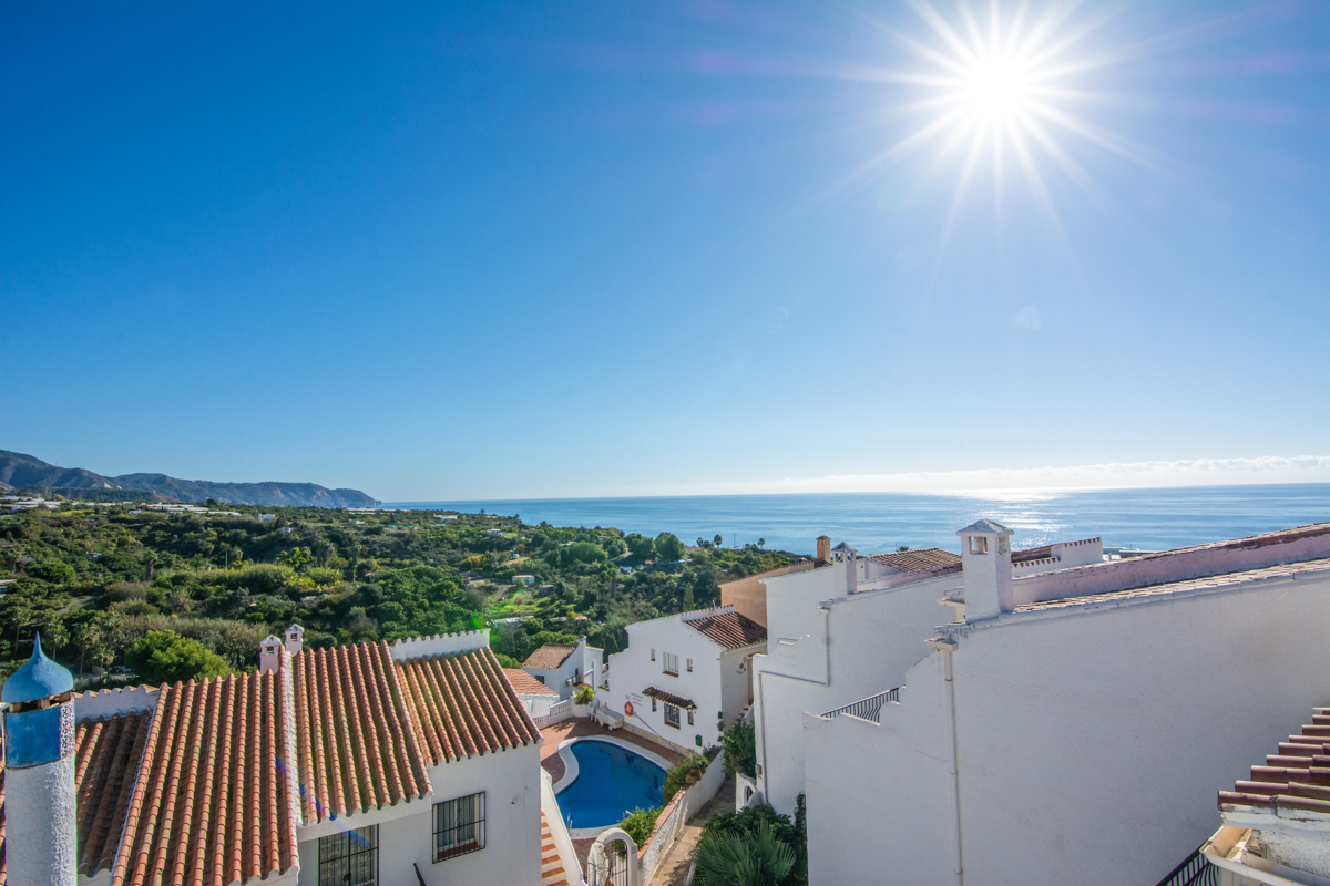Elevated views of the sea, pool and neighborhood