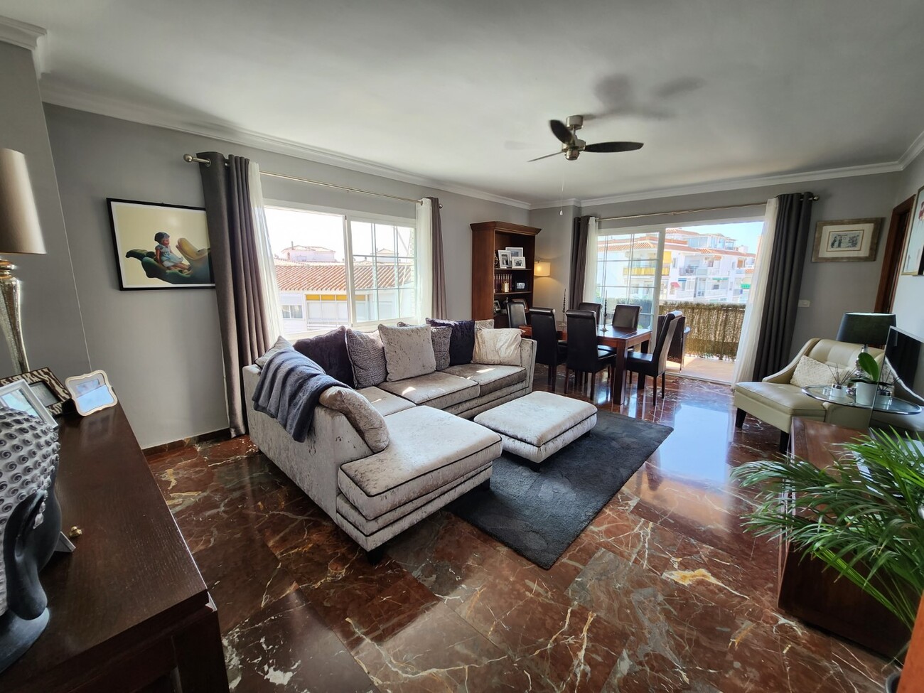 Bright living room with sectional sofa and dining area near terrace