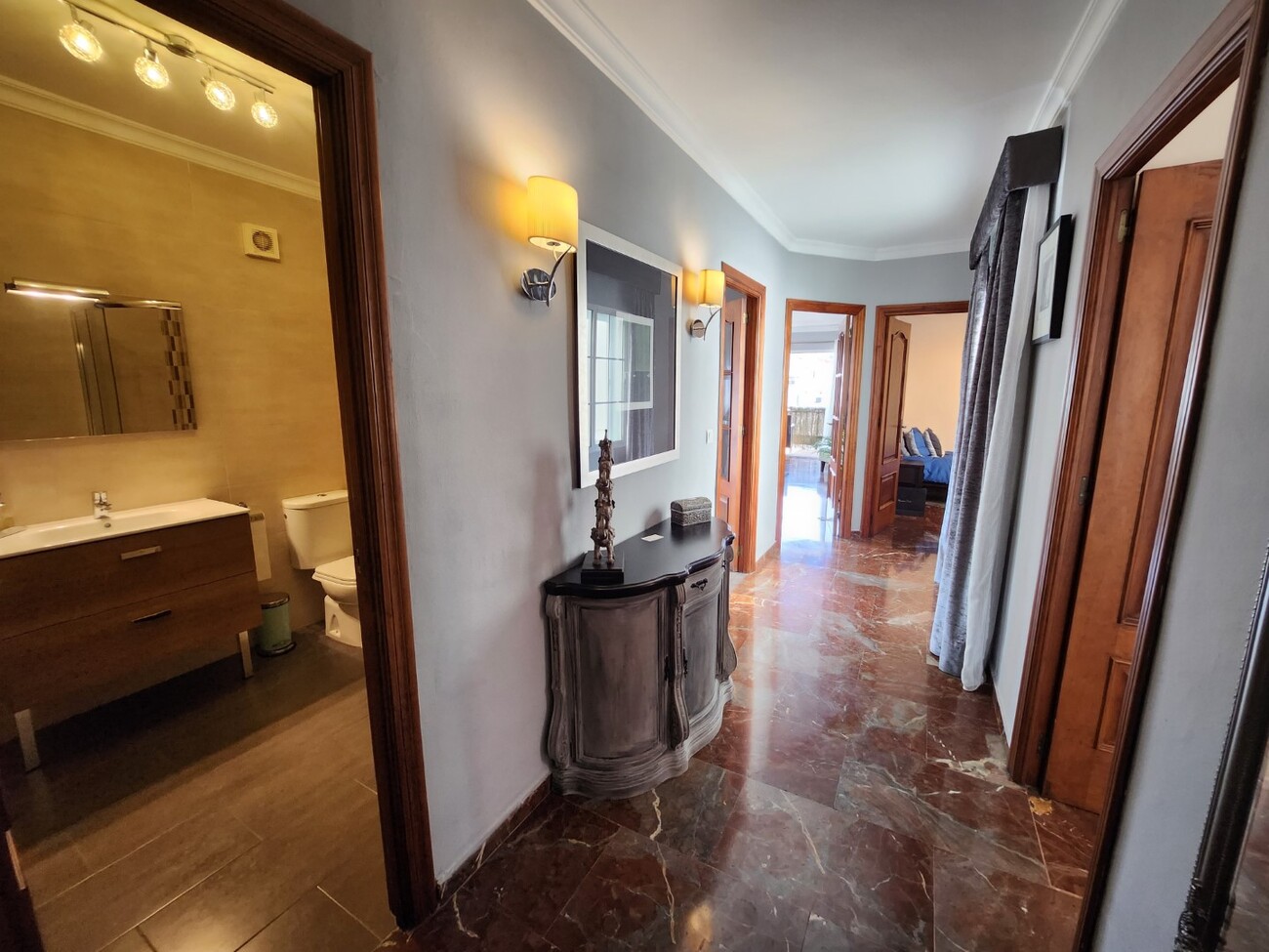 Hallway with access to bathroom and bedrooms