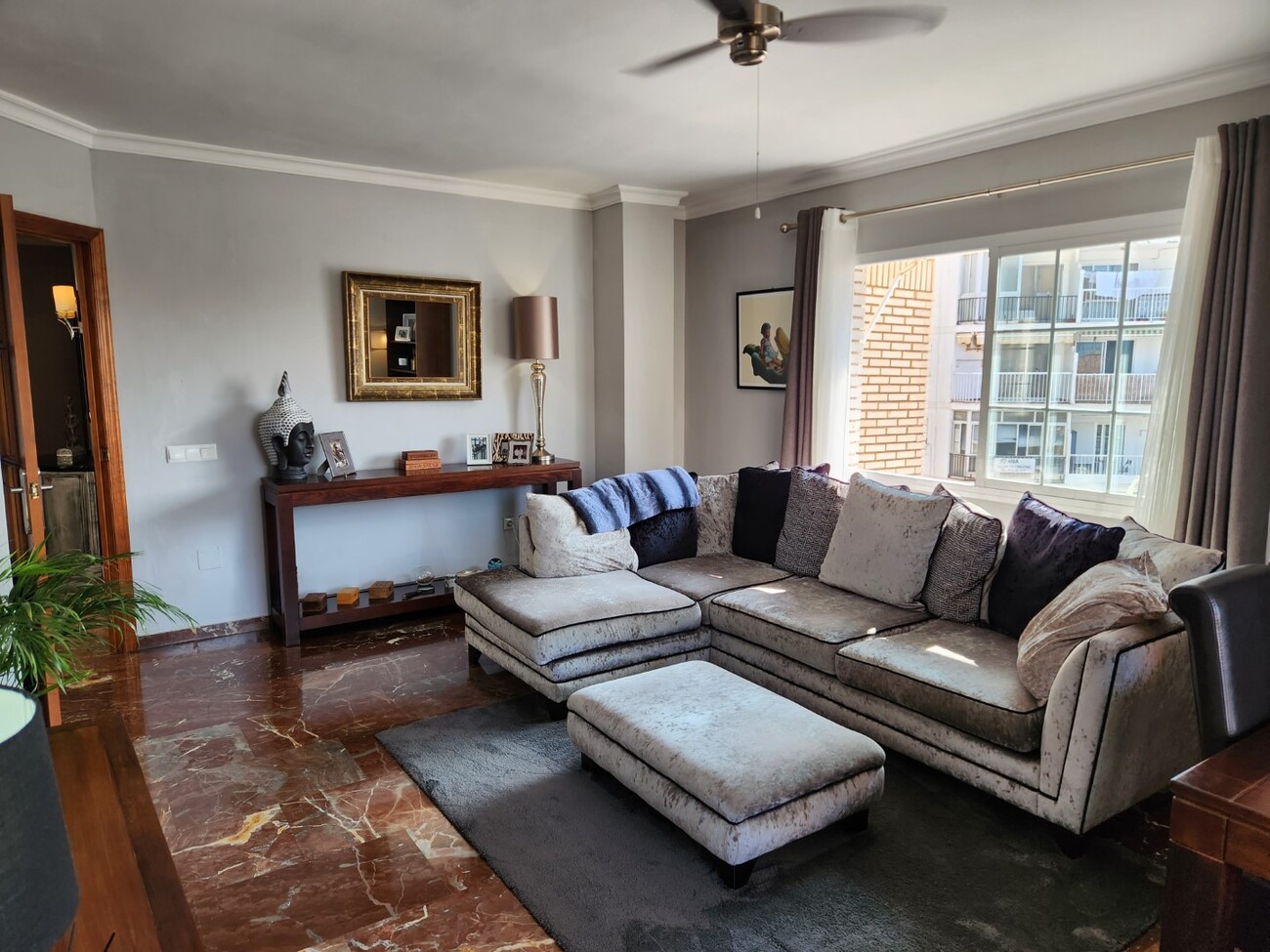 Living room with large sectional sofa and natural light