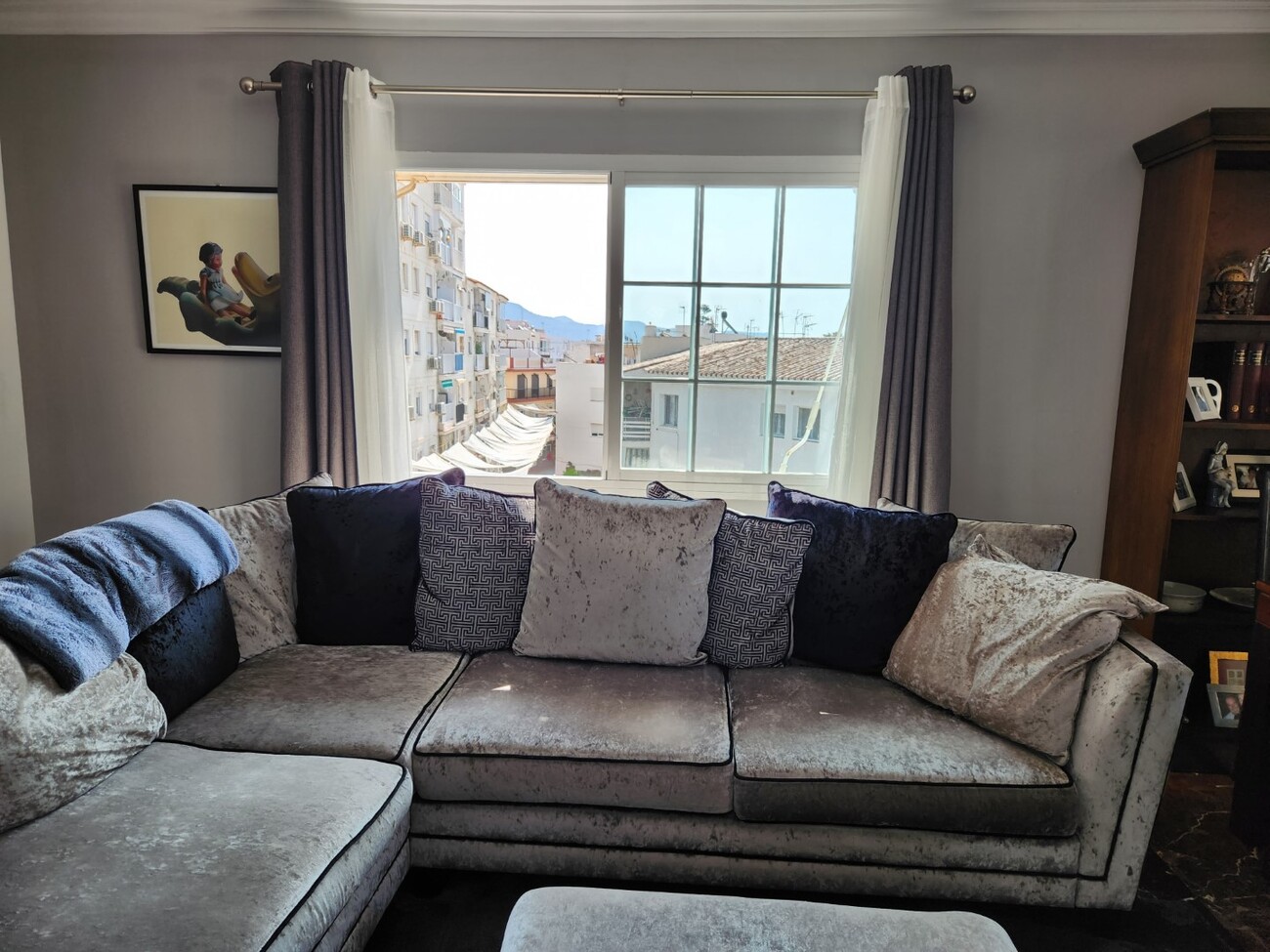 Living room with large sofa facing the window