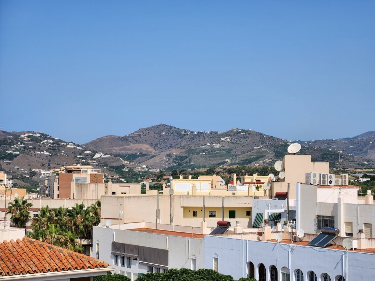 Panoramic views of mountains and nearby buildings