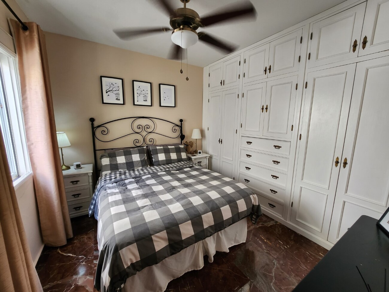 Bedroom with double bed and white wardrobes