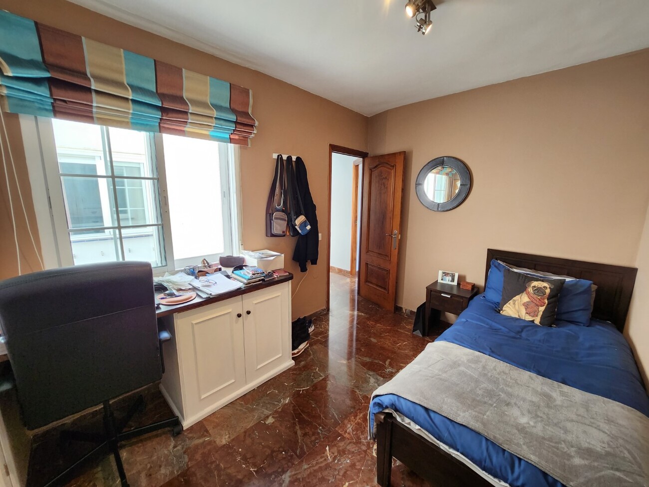 Single bedroom with desk and natural light
