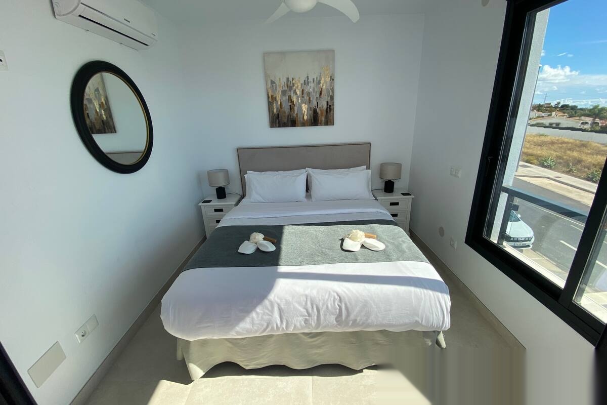Master bedroom with double bed and exterior views