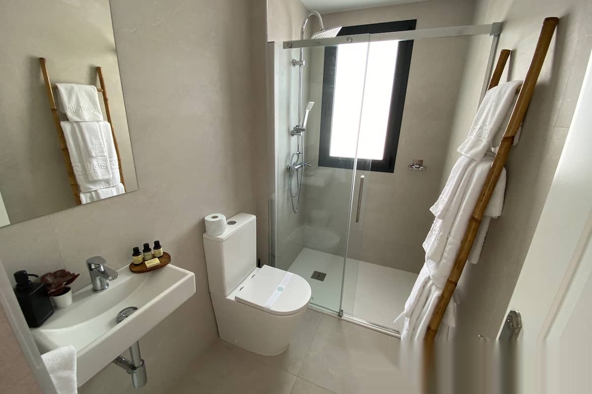 Full bathroom with shower, sink and towel rack