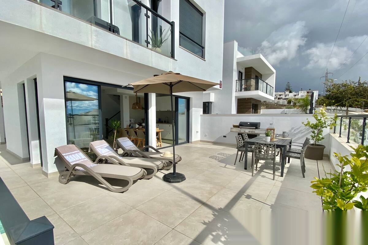 Large terrace with loungers, table and barbecue