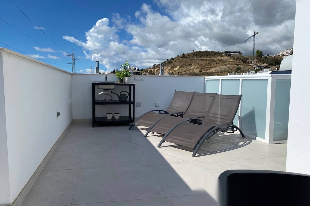 Terrace with loungers beside the pool