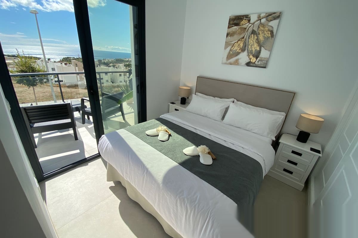 Double bedroom with terrace access and sea views