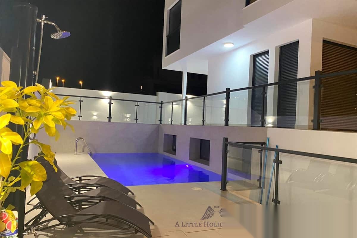 Nightlit pool with lounge area