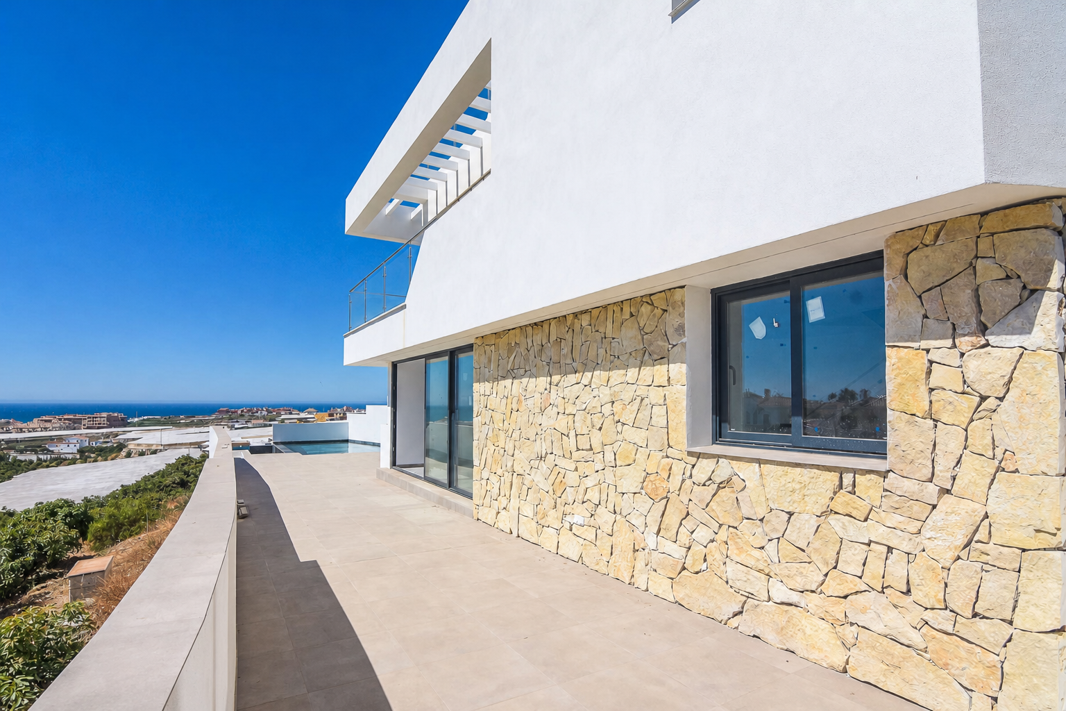 Side terrace with stone facade and views