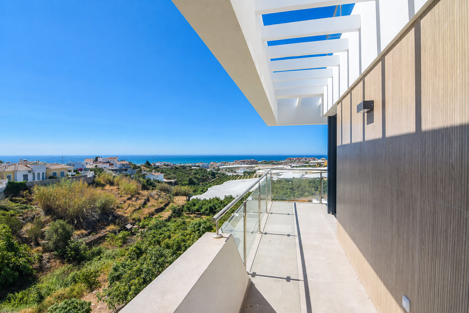 Terrace with glass railing and sea views