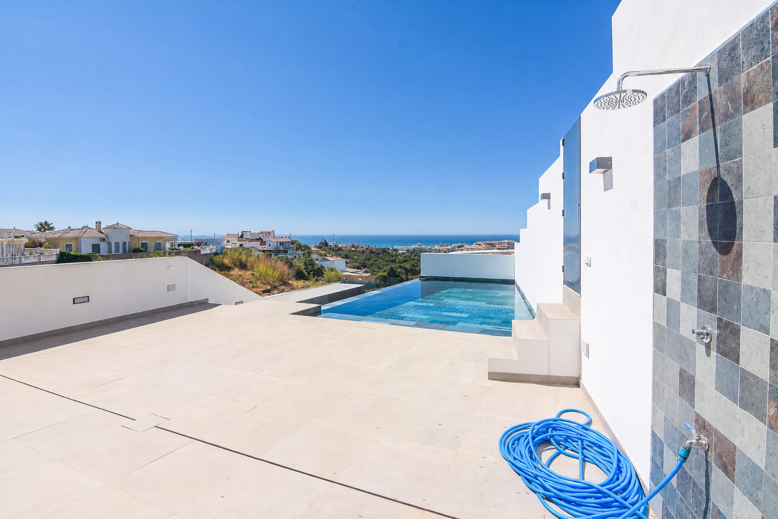 Laundry or outdoor shower area beside the pool
