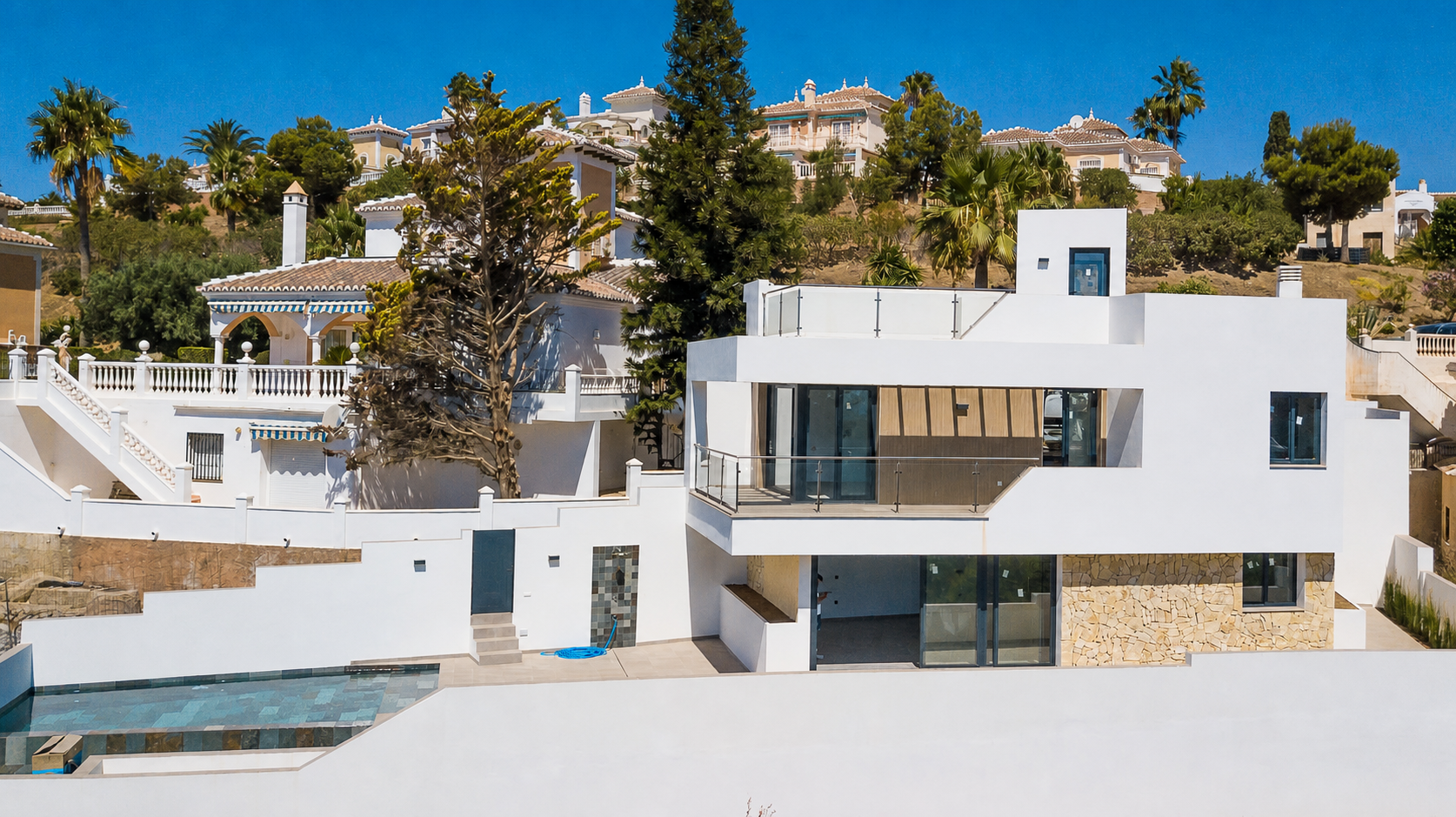 Side and rear facade with pool and terraces