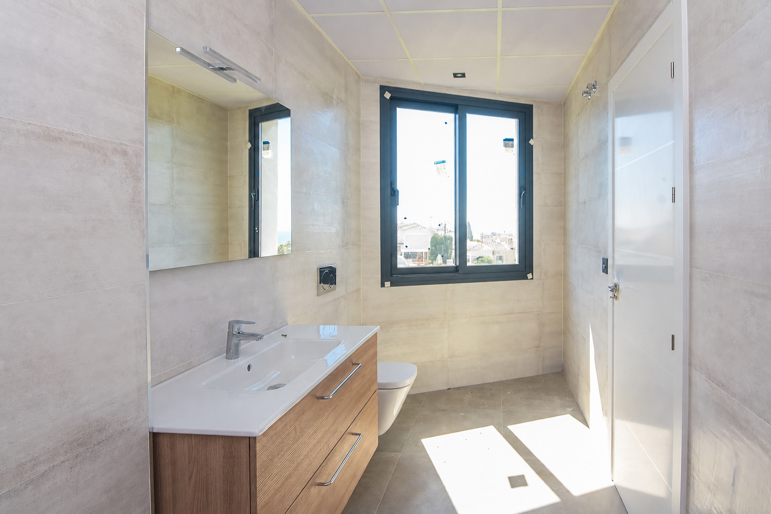 Bathroom with sink, toilet and exterior window